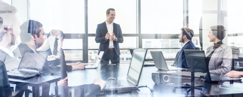 presenter in front of group of colleagues during a business meeting